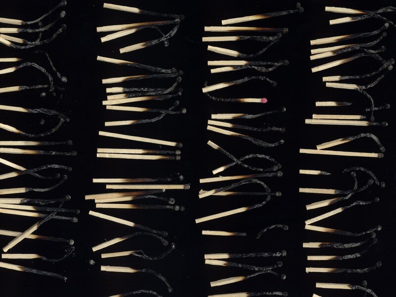 Burnt matches on black background