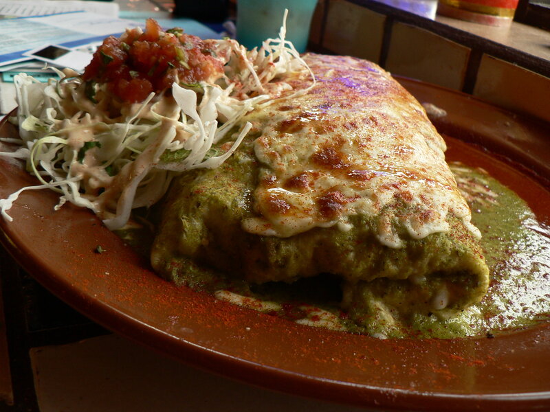 burrito with green sauce and slaw
