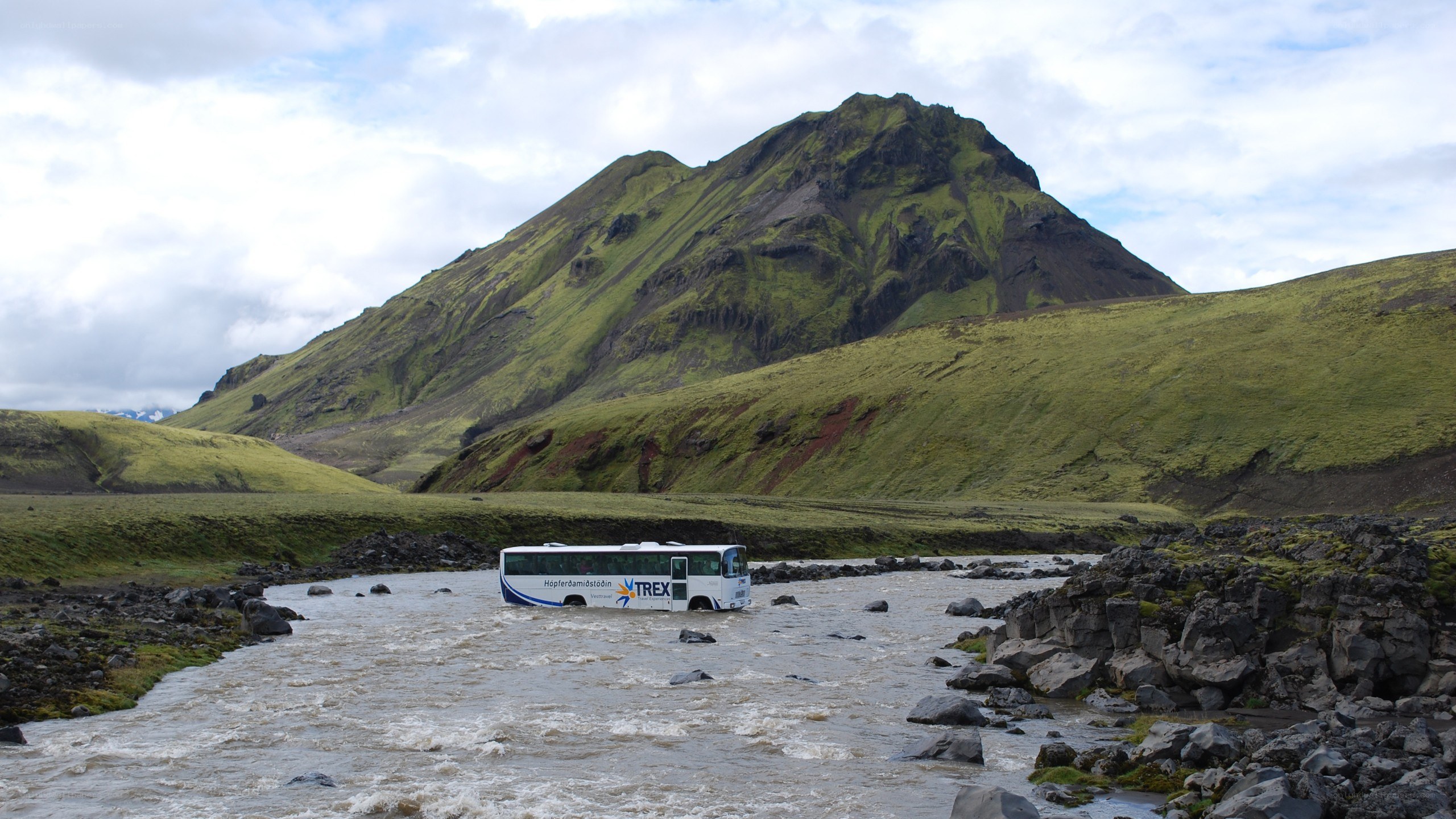 Bus crossing a river in Iceland