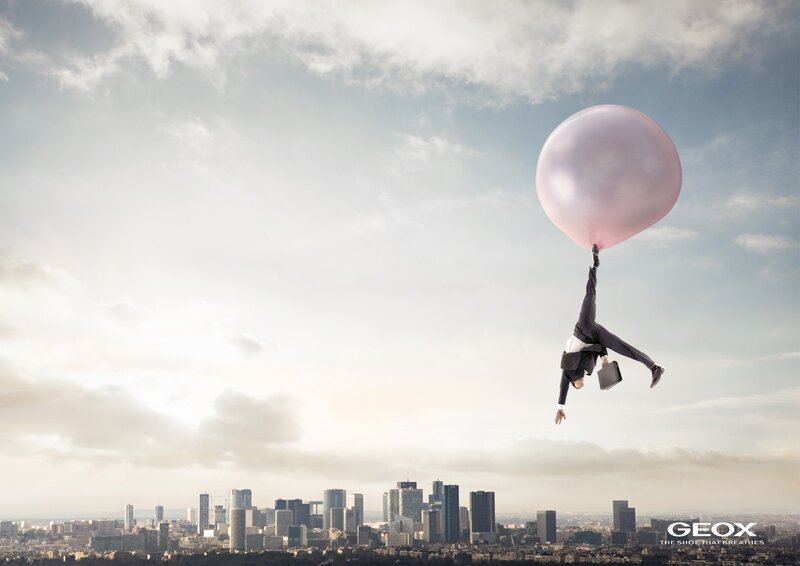 Businessman floating with balloon