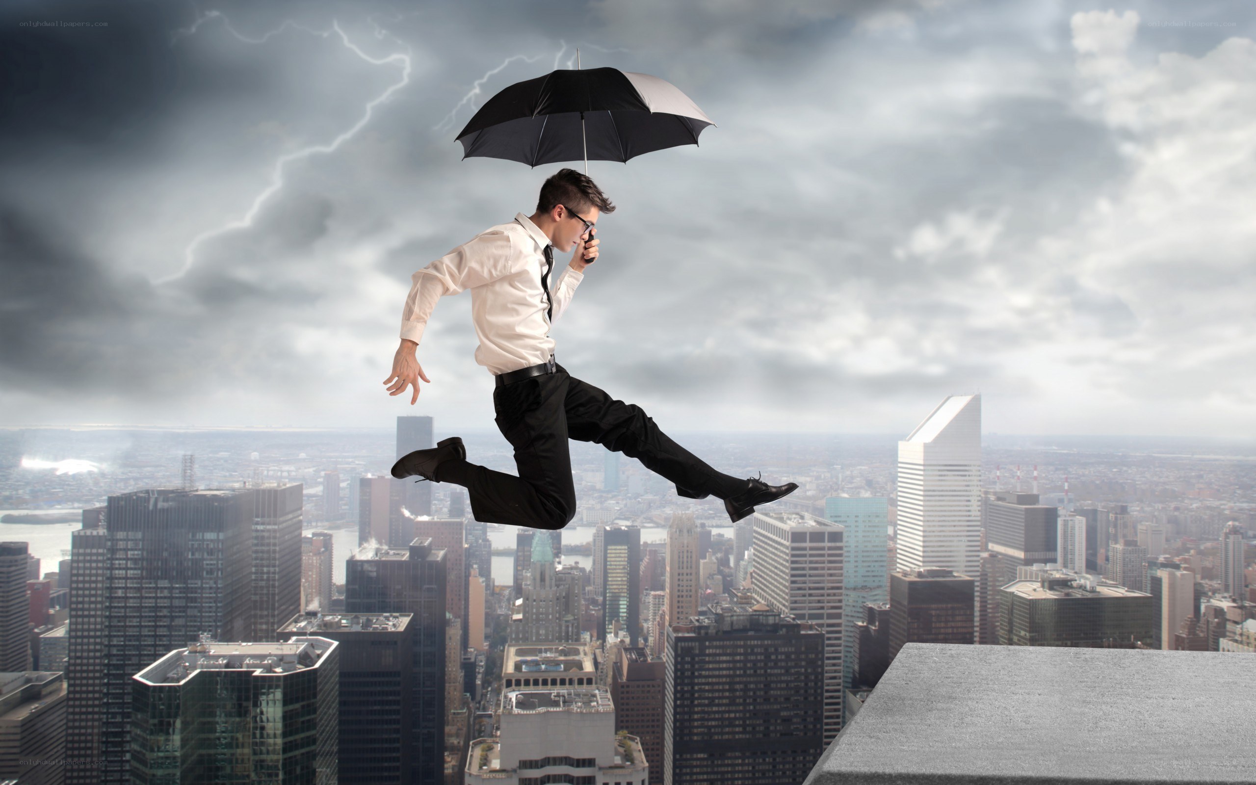 Businessman jumping with umbrella