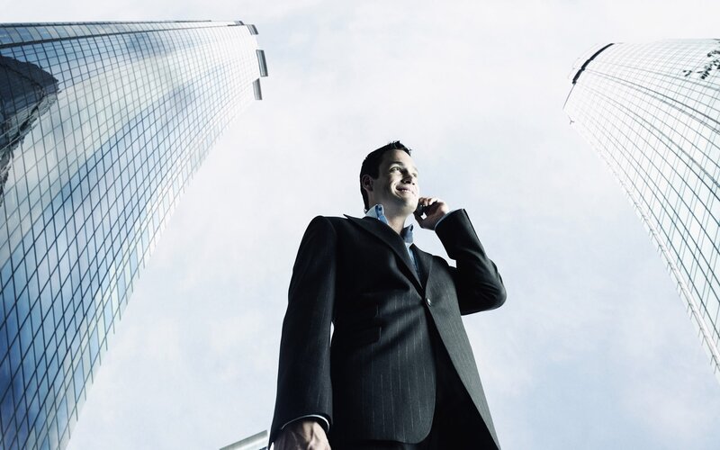 Businessman on phone in city