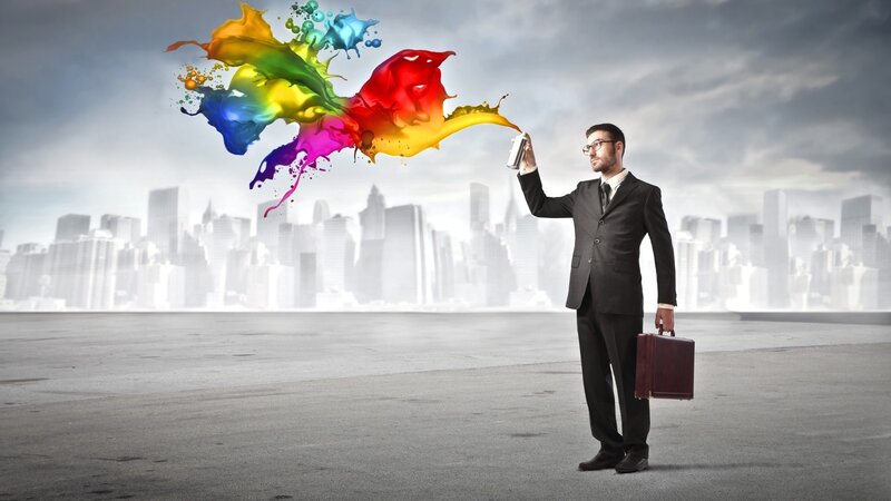 Businessman with colorful paint spray