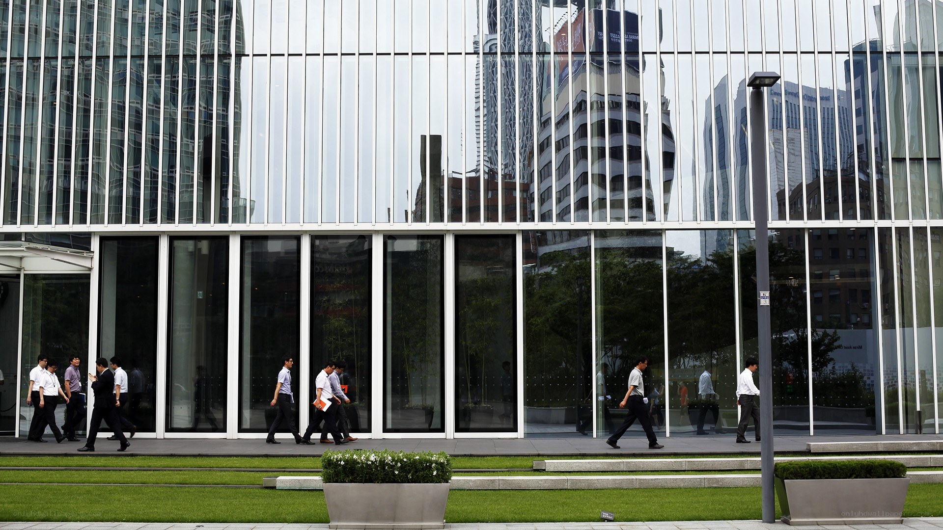 Businessmen walking past modern building