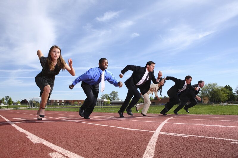 Businesspeople running on a track