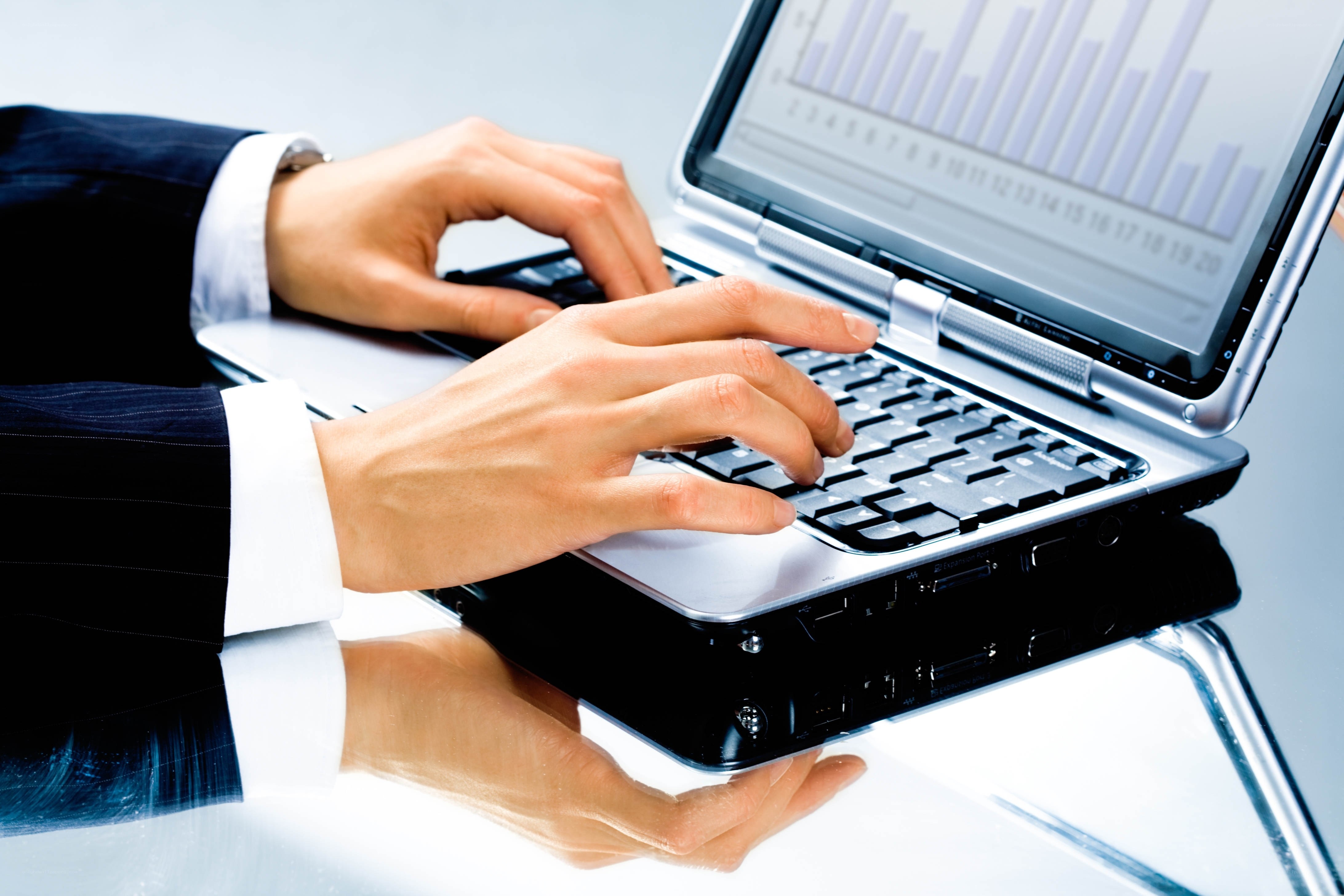 Businessperson typing on laptop
