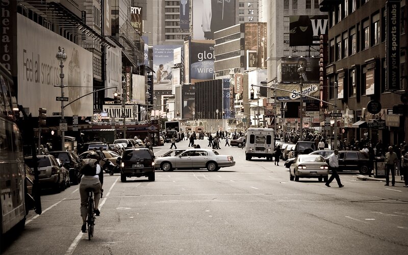 Busy city street with pedestrians and traffic