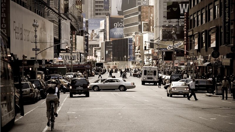 Busy city street with traffic and pedestrians