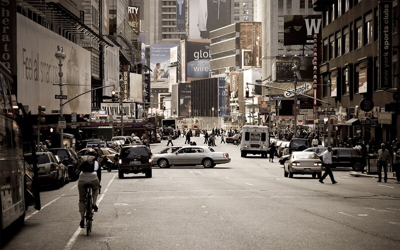 Busy city street with traffic and pedestrians