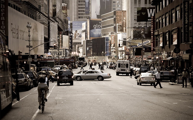 Busy city street with traffic and pedestrians