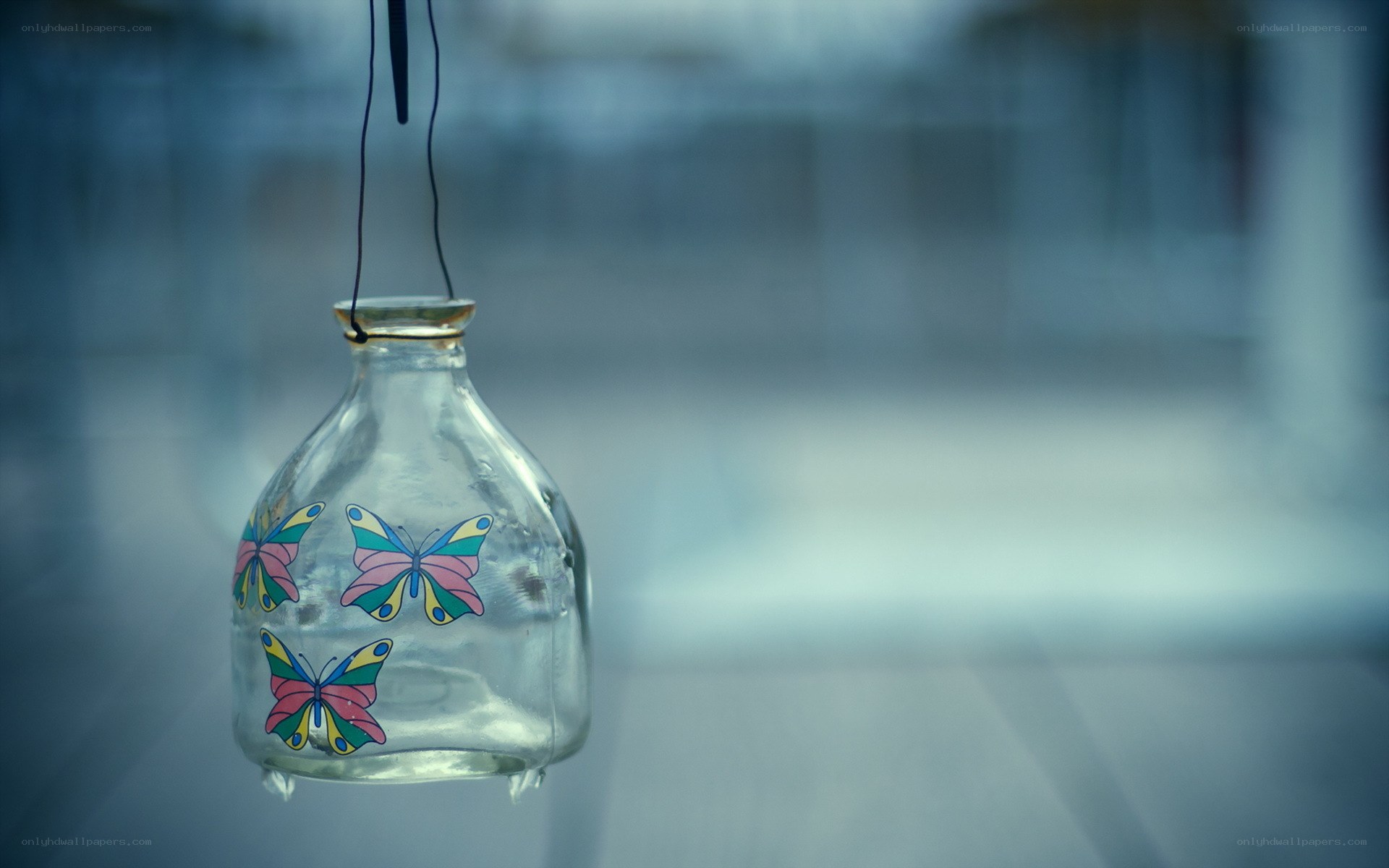 butterfly-decorated glass bottle