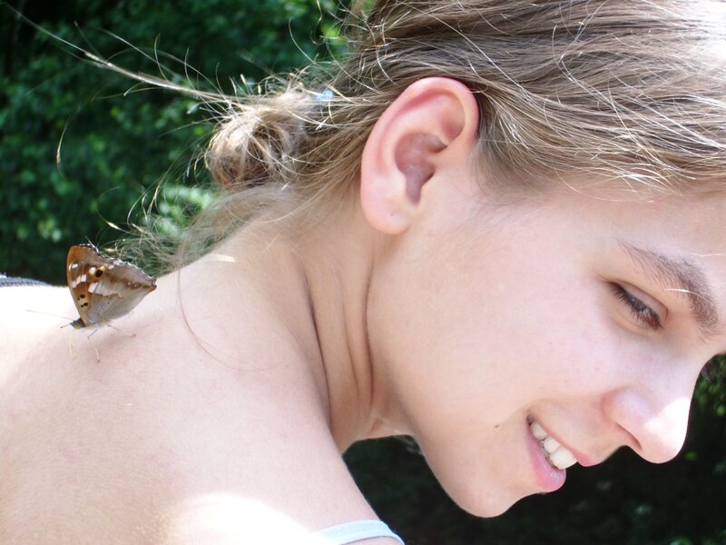 butterfly on woman's shoulder