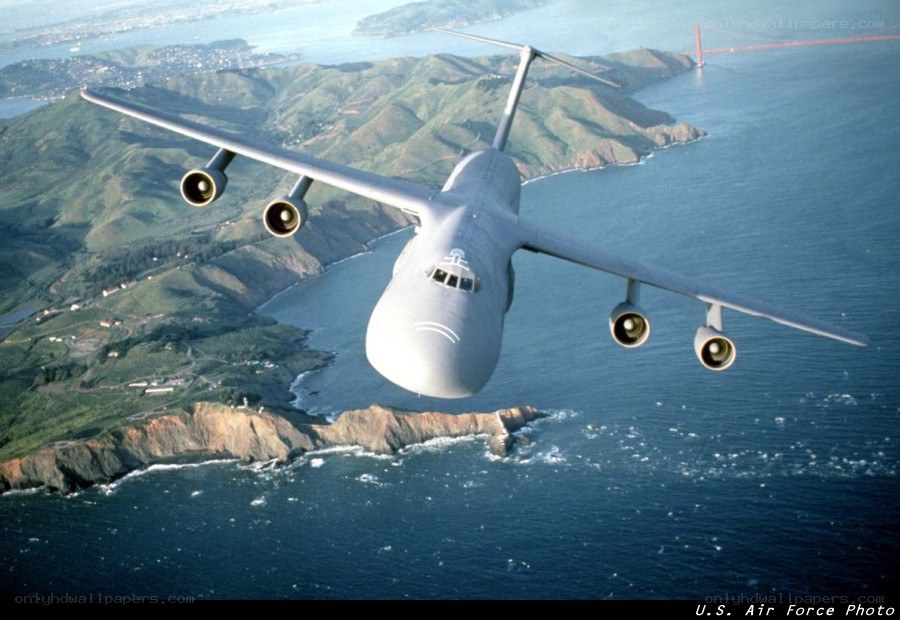 C-5 Galaxy over coastal landscape