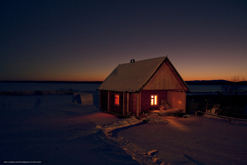 Cabin at dusk in snowy landscape