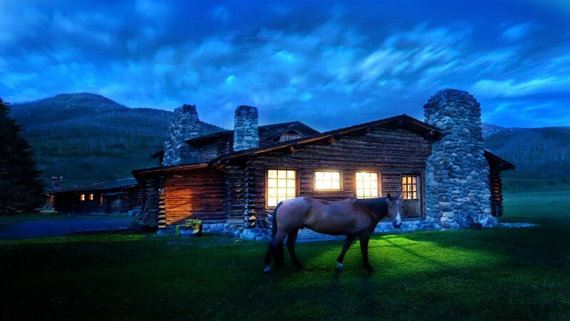 Cabin at dusk with horse
