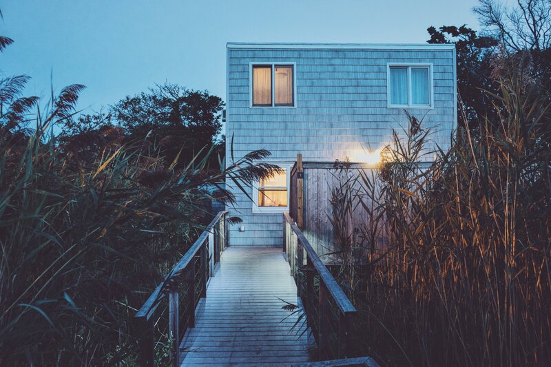 Cabin at dusk with wooden walkway