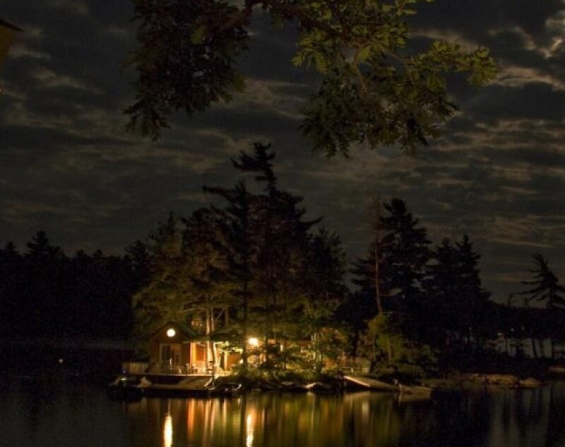 Cabin at night on a lake