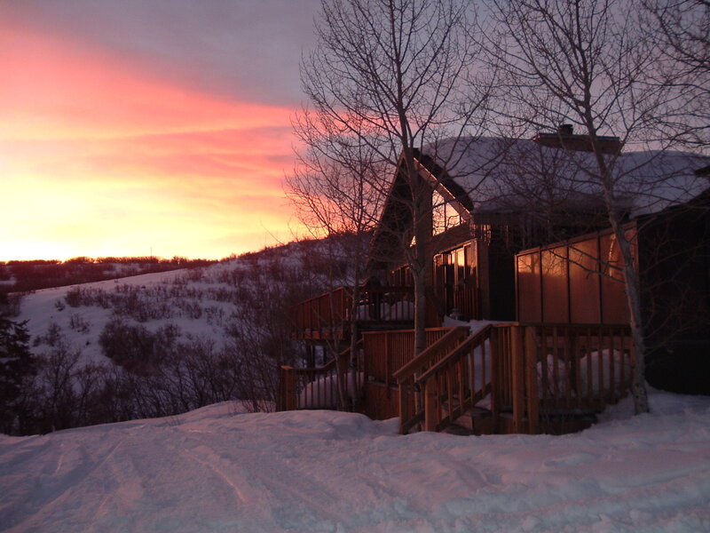 Cabin at sunset in snowy landscape