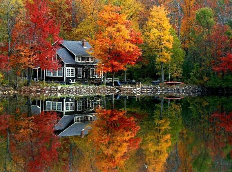 Cabin by a lake in autumn