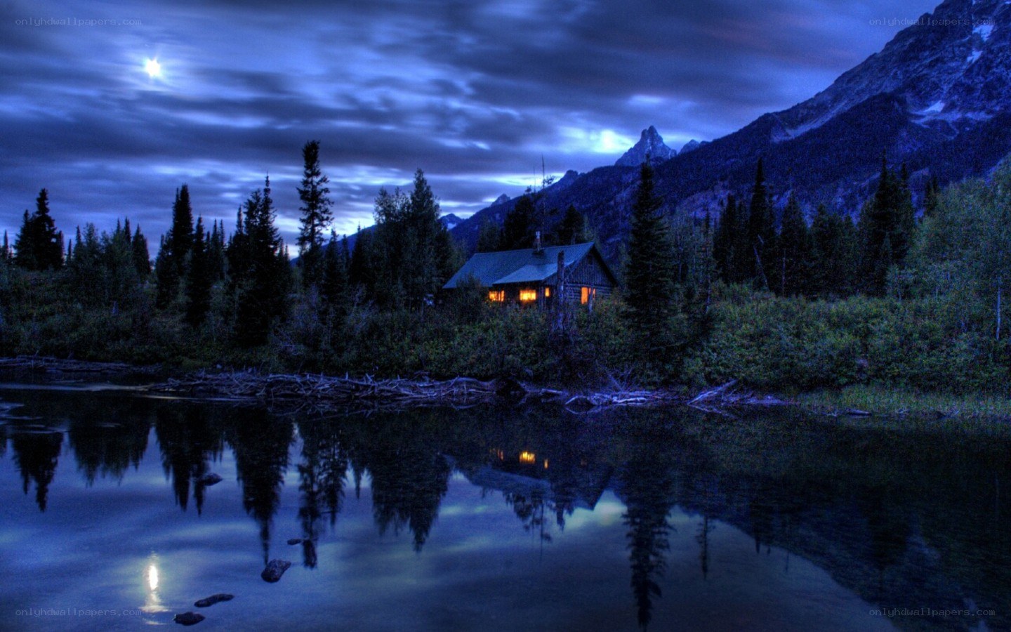 Cabin by the lake at night