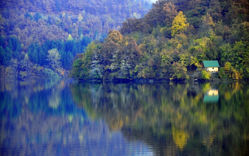 Cabin by the lake in autumn