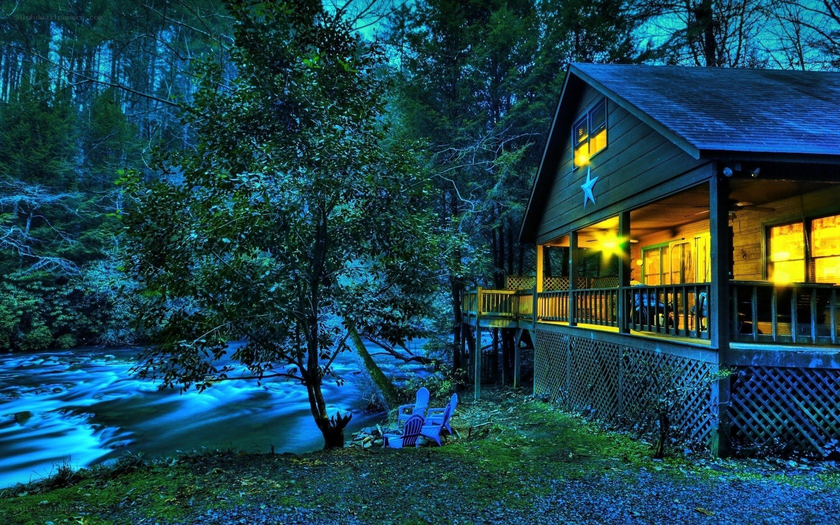 Cabin by the river at night