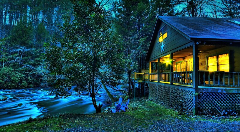 Cabin by the river at night