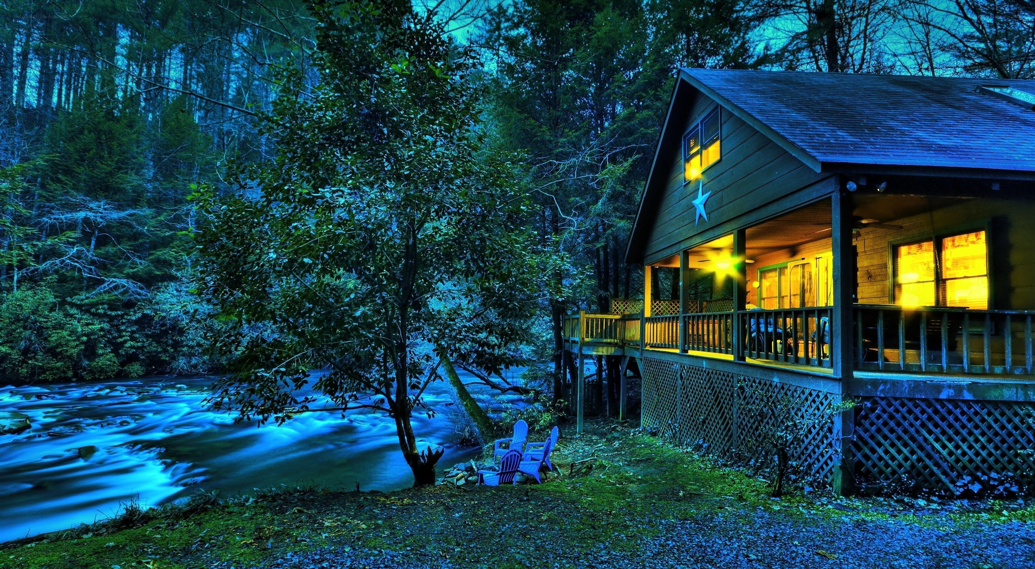Cabin by the river at night