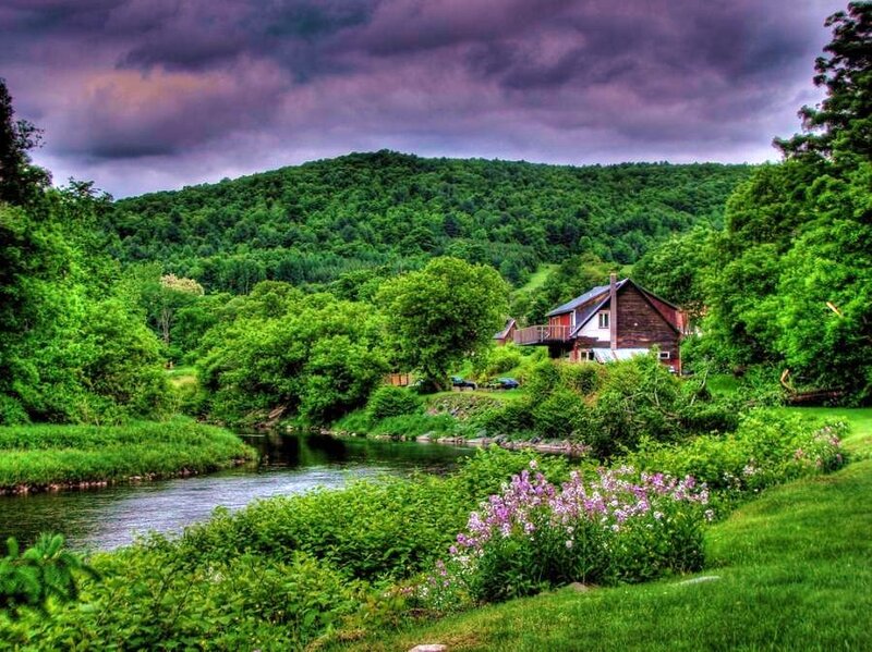 Cabin by the river in green valley