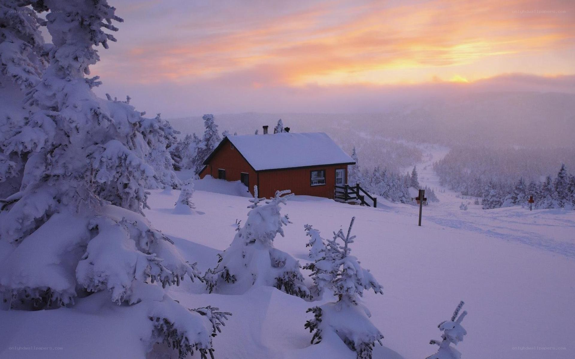 Cabin in snowy landscape at sunset