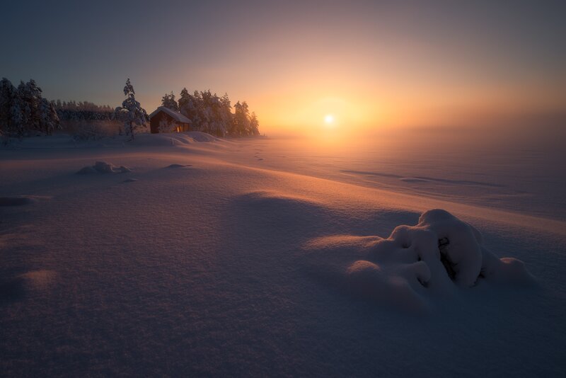 Cabin in Snowy Landscape — Orange, Serene, Sunset