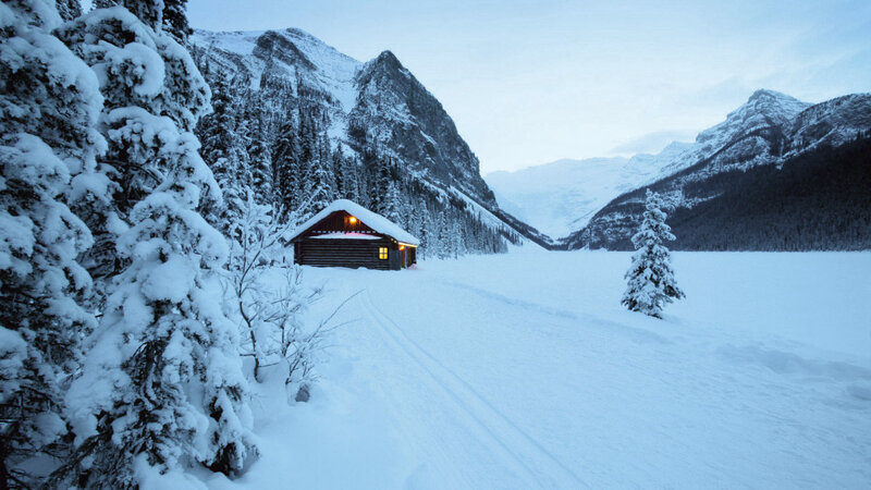 Cabin in snowy mountain valley