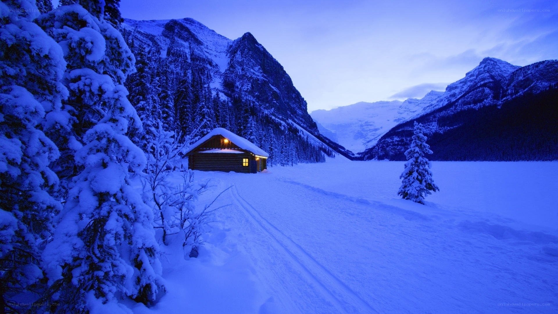 Cabin in snowy mountain valley