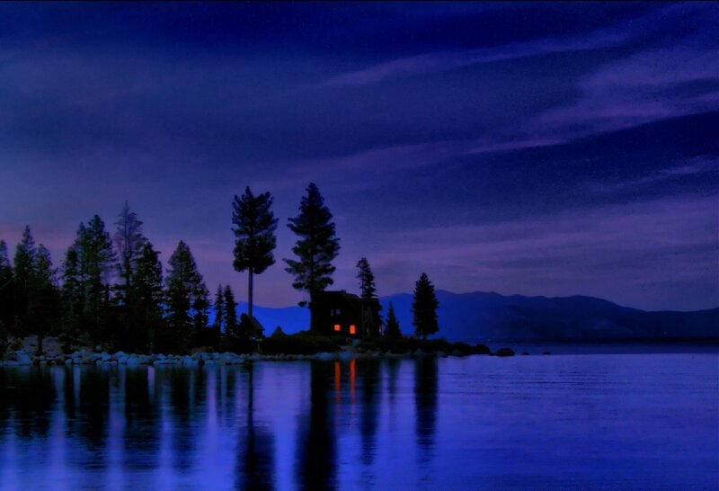 Cabin on a lake at night