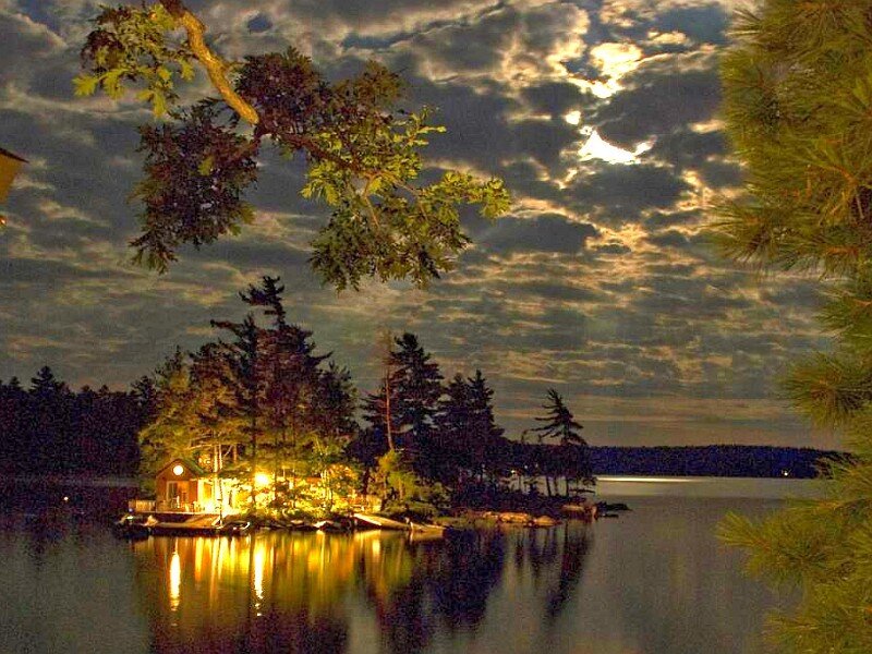 Cabin on a lake at night