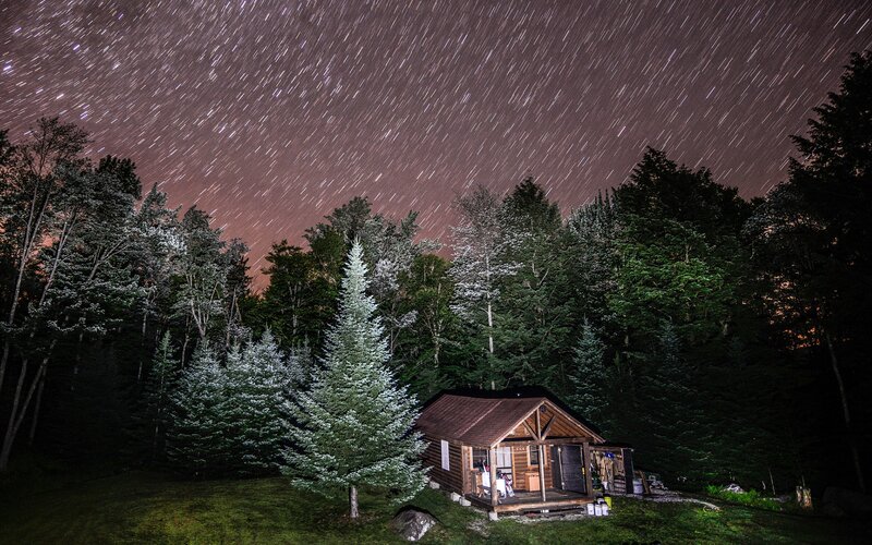 Cabin under star trails