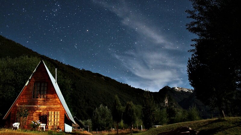 Cabin under starry night sky