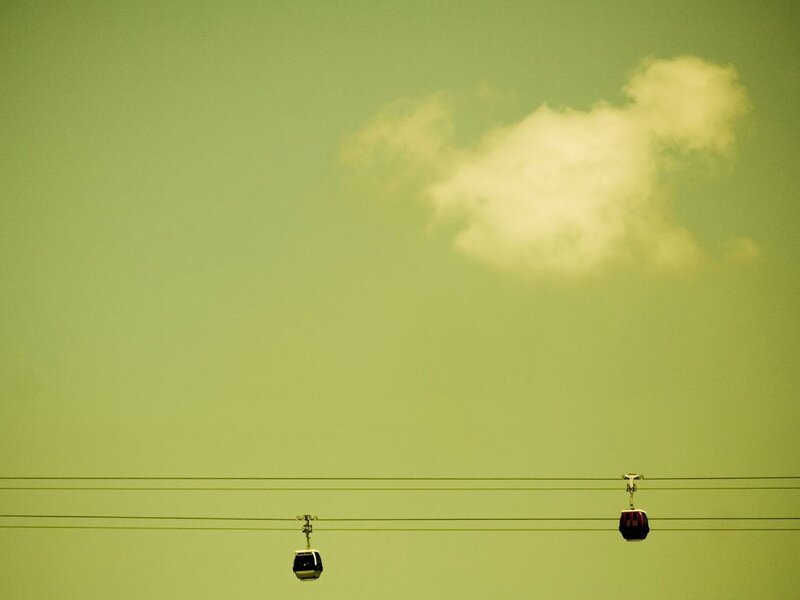 Cable cars against a green sky