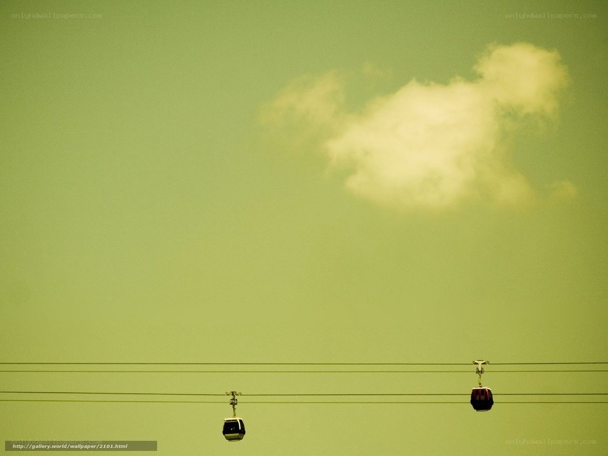 Cable cars against green sky