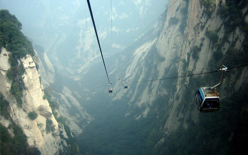 Cable cars over a mountain gorge