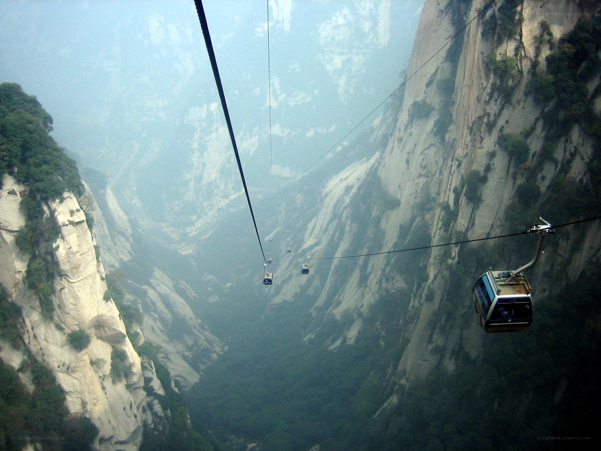 Cable cars over a mountain gorge