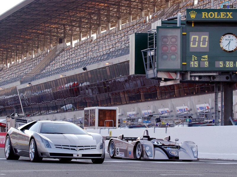 Cadillac and race car on track