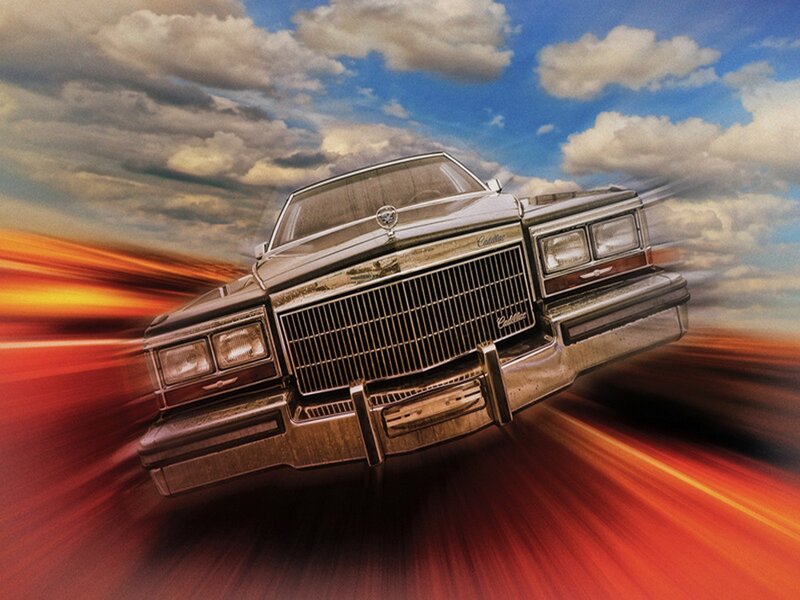 Cadillac speeding on a road
