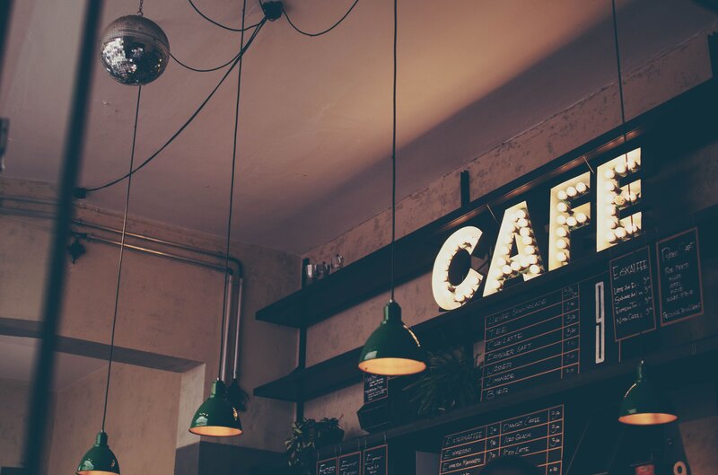 cafe with disco ball and neon sign