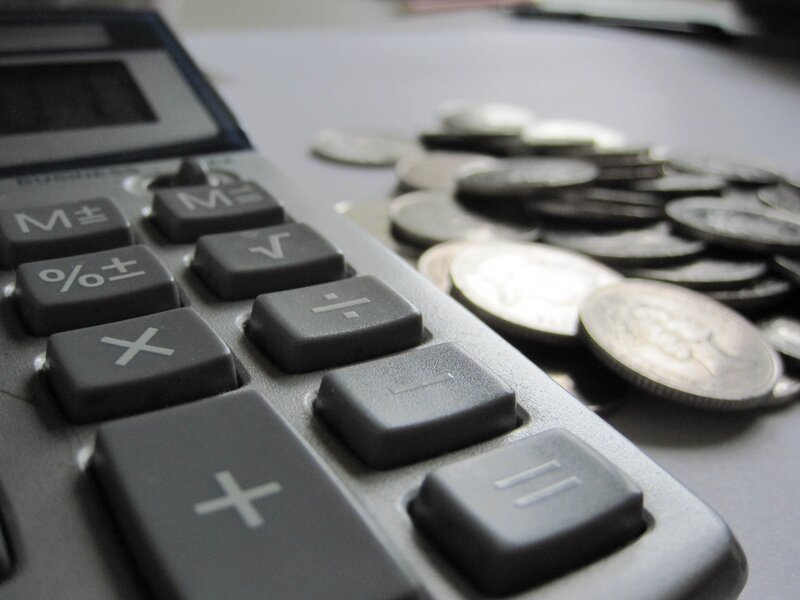 calculator and coins on table