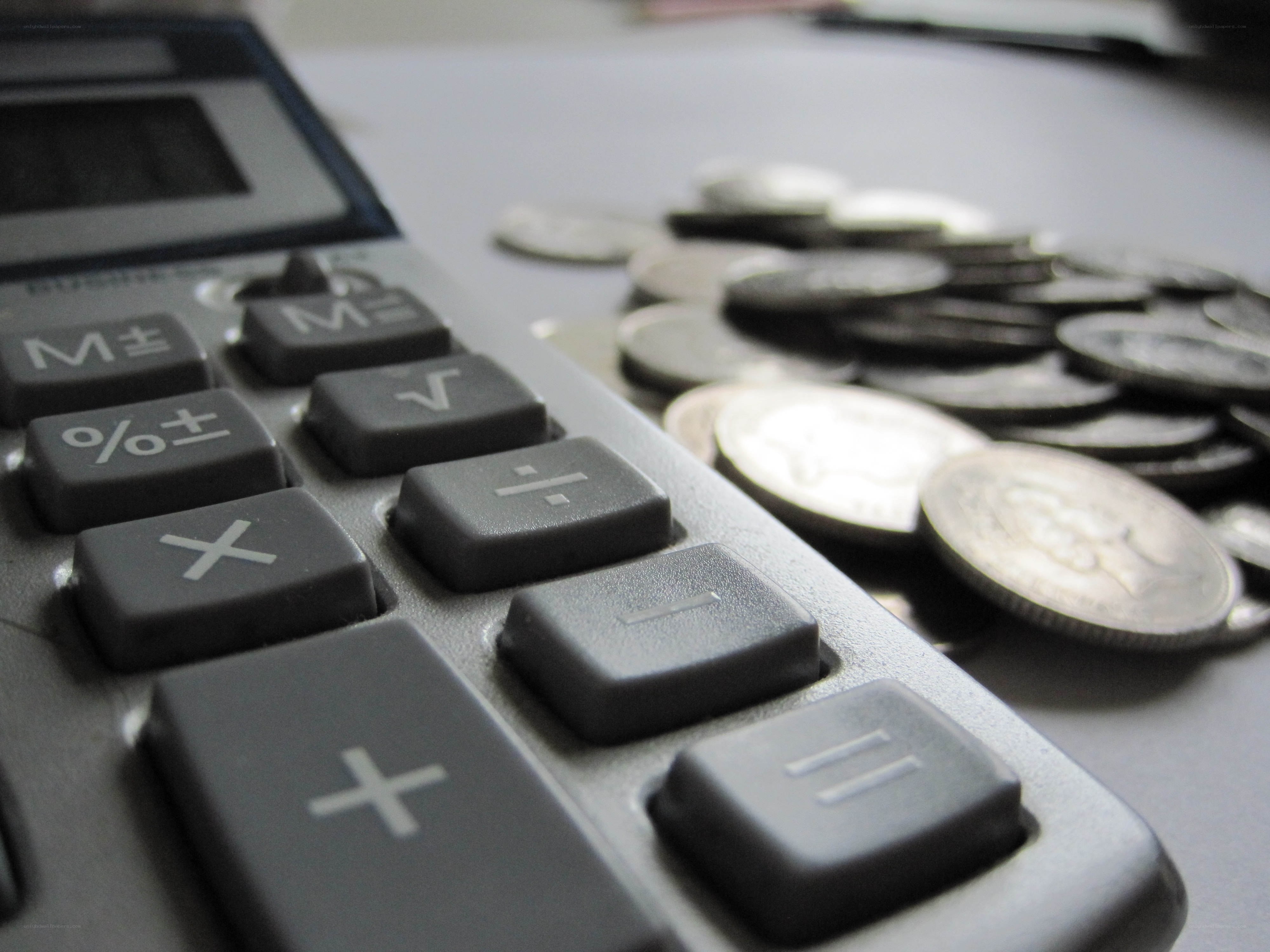 calculator and coins on table