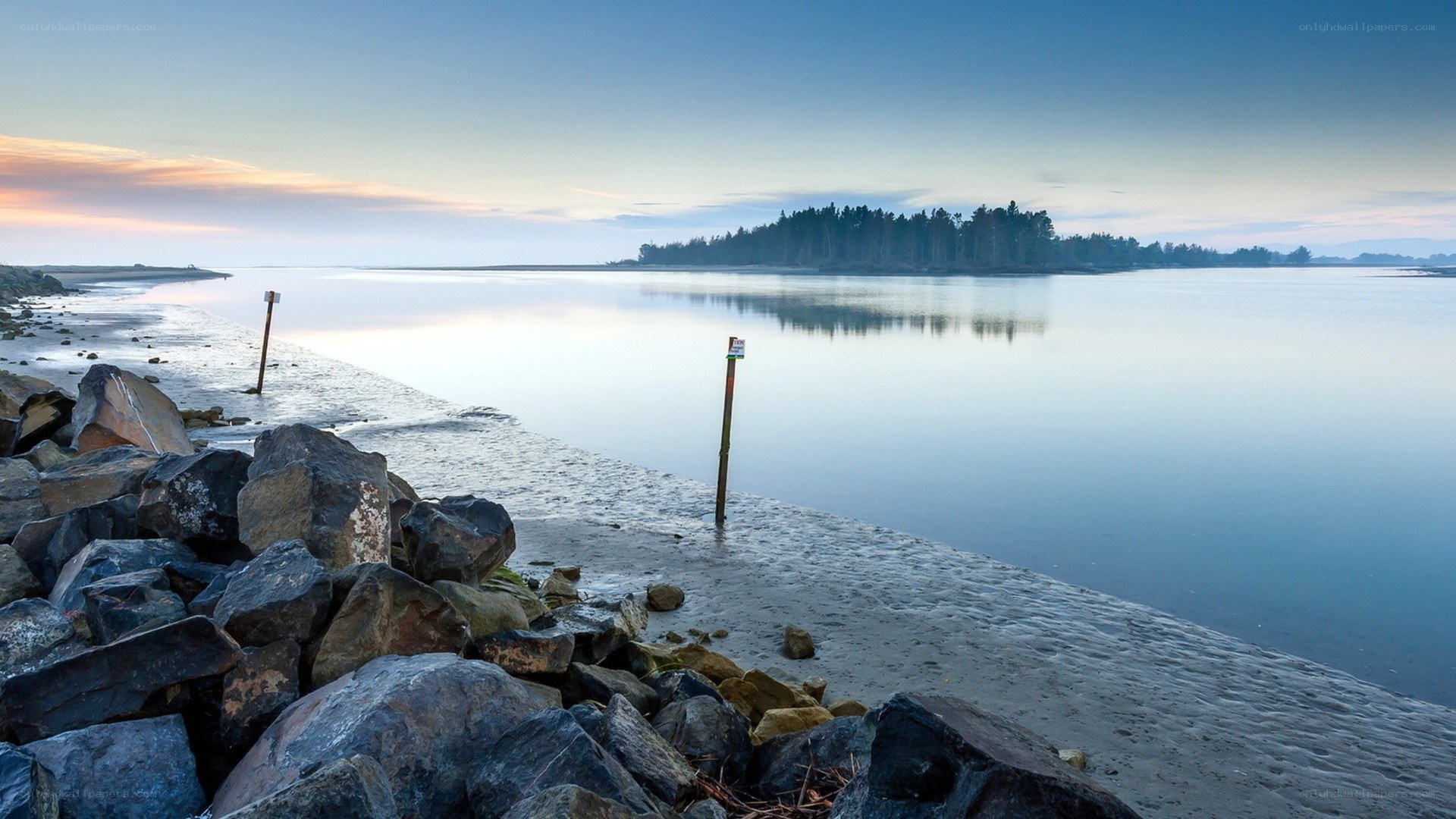 Calm beach at dawn with island