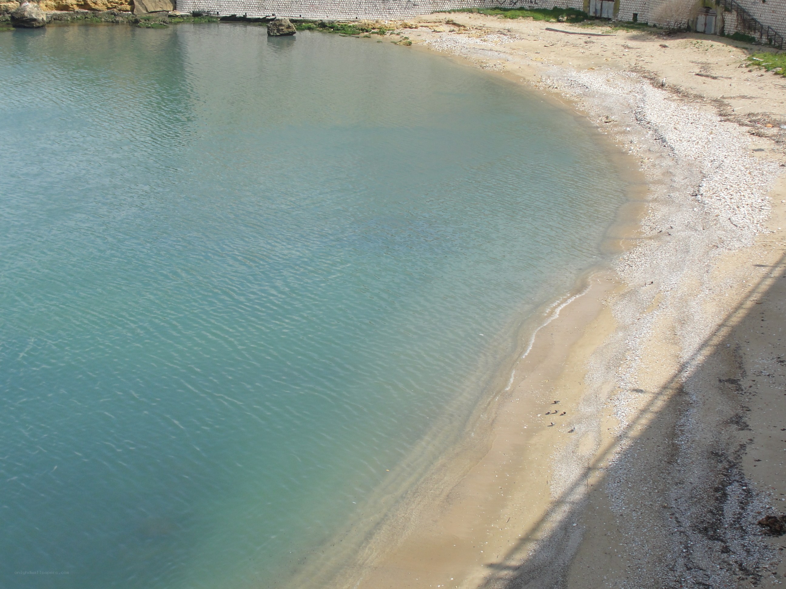 Calm beach cove with pebble shore