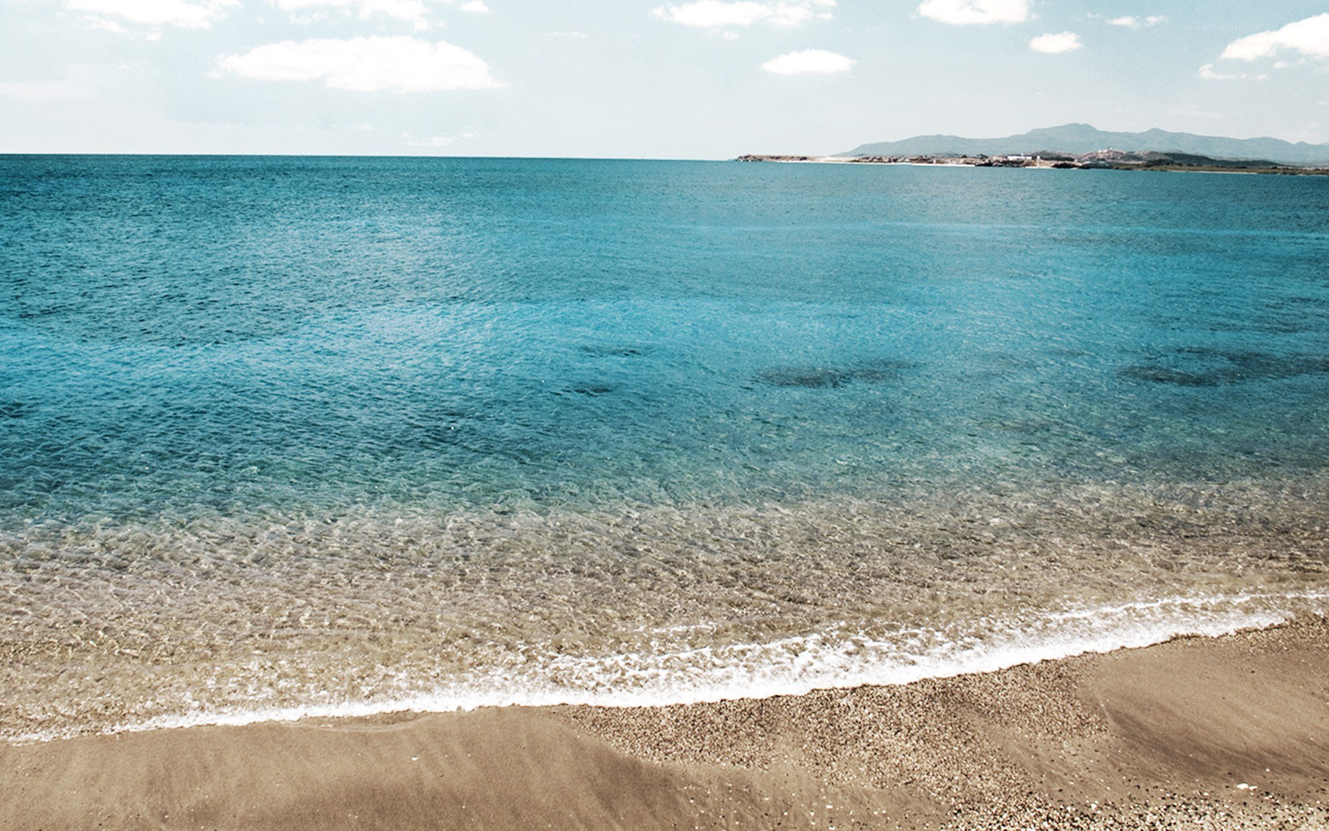 Calm beach with clear blue water