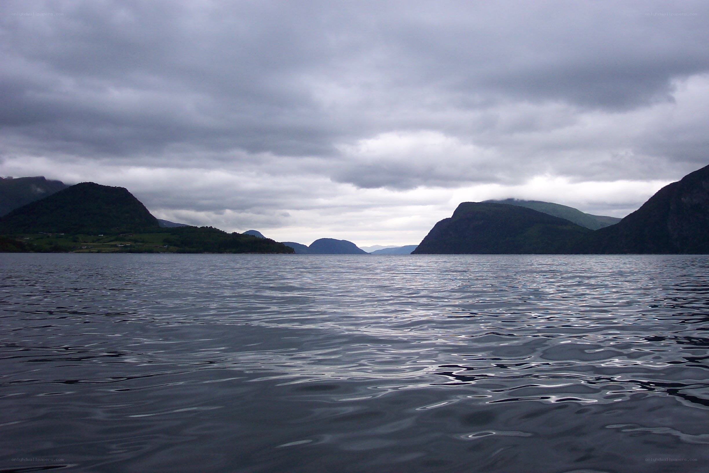 calm fjord under cloudy sky